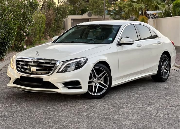 White Mercedes S-Class sedan parked on a driveway