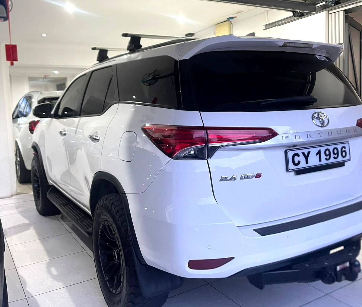 White Toyota Fortuner photographed in a garage